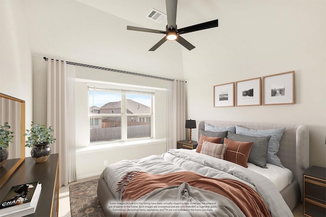 bedroom with carpet floors, a high ceiling, visible vents, and a ceiling fan