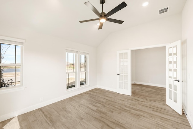 unfurnished room with french doors, visible vents, light wood-style flooring, and baseboards