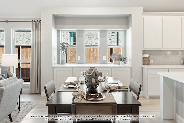 dining space with plenty of natural light and light wood-type flooring