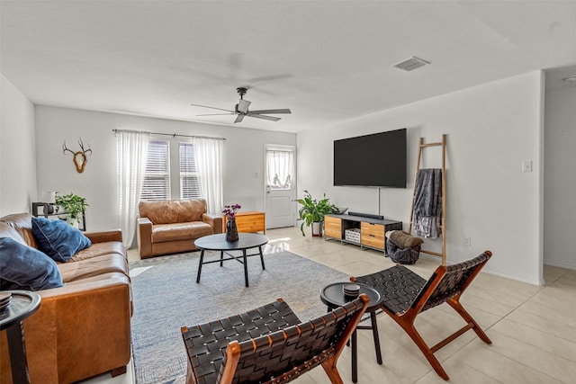 tiled living room with ceiling fan