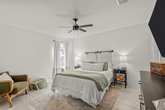 bedroom with ceiling fan and light tile patterned flooring