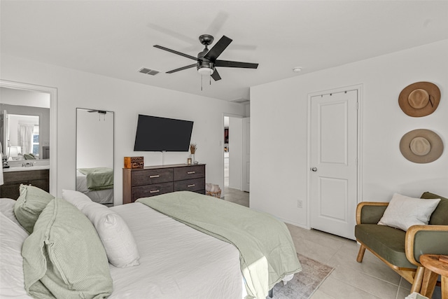 tiled bedroom featuring ceiling fan and ensuite bathroom