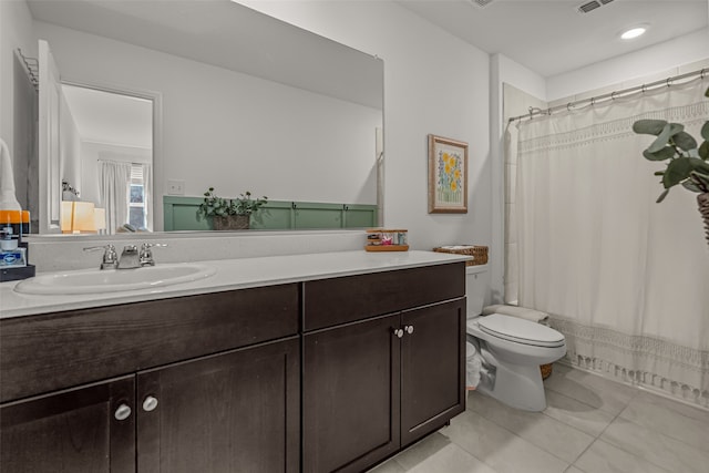 full bathroom with shower / bath combo with shower curtain, tile patterned floors, toilet, and vanity