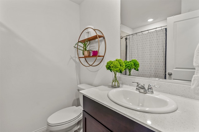 bathroom featuring toilet, a shower with curtain, and vanity