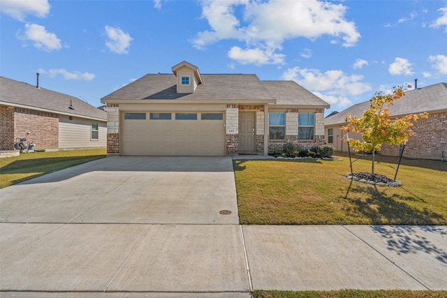 view of front of property featuring a garage and a front lawn