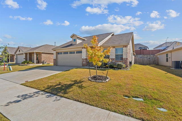 view of front of property featuring cooling unit, a garage, and a front yard