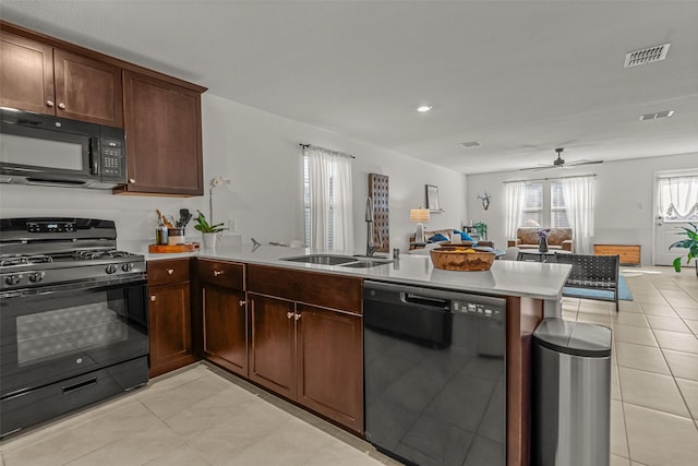 kitchen with black appliances, kitchen peninsula, sink, and ceiling fan