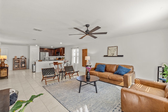 tiled living room with ceiling fan