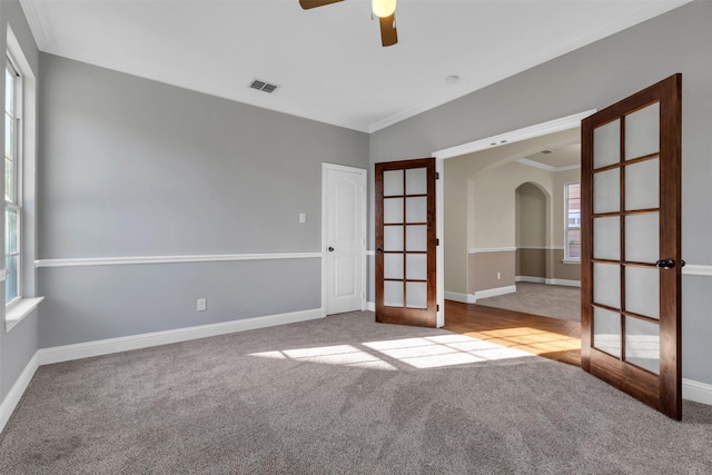 unfurnished room with light carpet, french doors, and ornamental molding