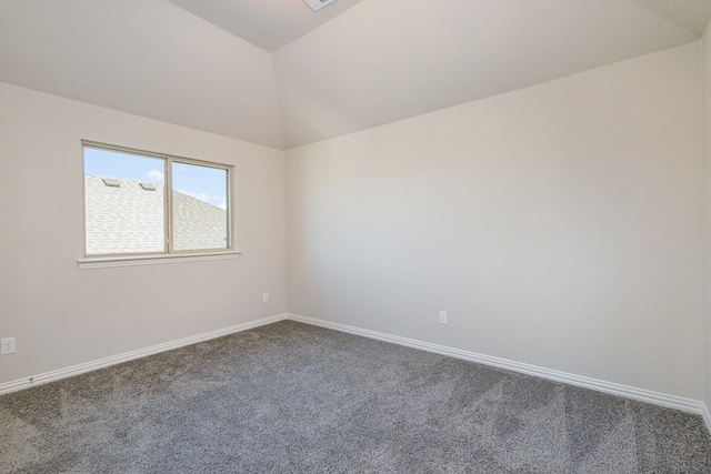 spare room featuring lofted ceiling and carpet floors