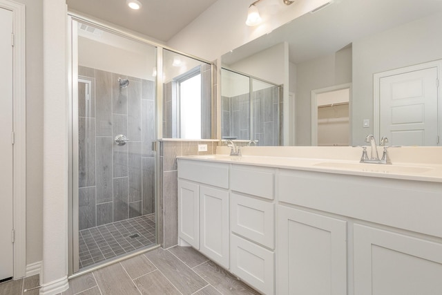 bathroom featuring vanity and a shower with shower door