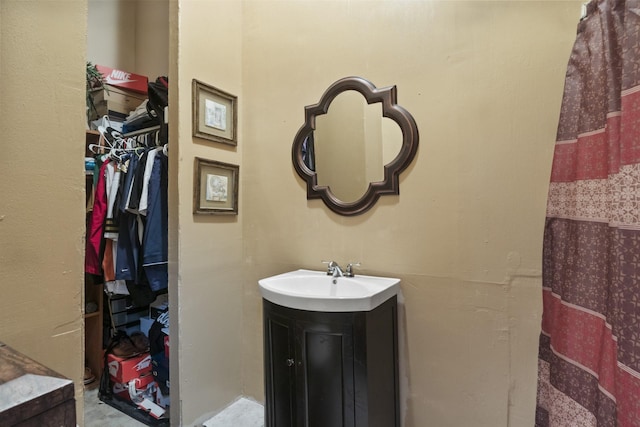 full bath with a spacious closet and vanity