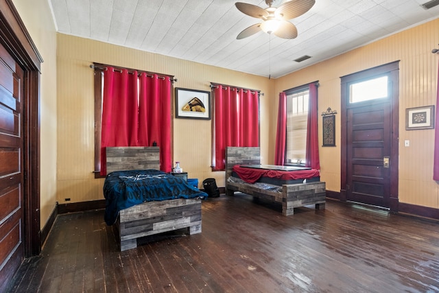 bedroom featuring a ceiling fan, baseboards, visible vents, and dark wood-type flooring