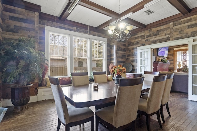 dining room with beam ceiling, coffered ceiling, dark wood finished floors, and visible vents