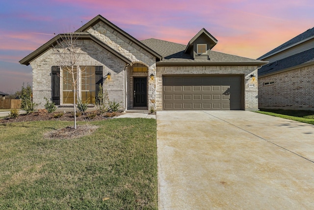 view of front of property with a lawn and a garage