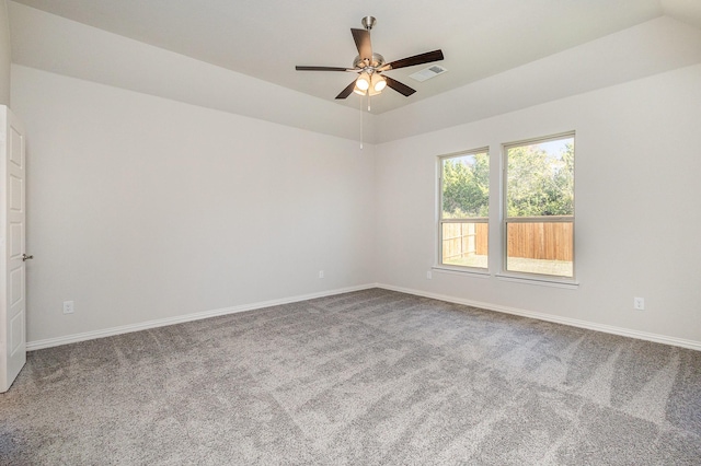 carpeted spare room featuring ceiling fan and vaulted ceiling