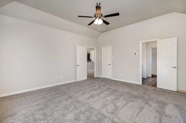 unfurnished bedroom featuring high vaulted ceiling, dark carpet, and ceiling fan