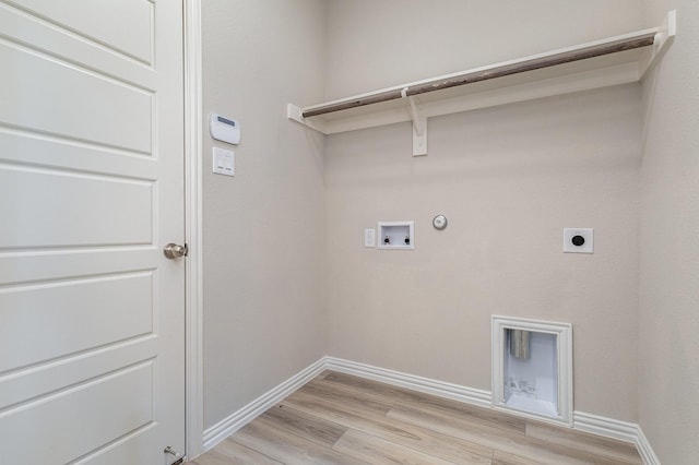 washroom with hookup for an electric dryer, washer hookup, light hardwood / wood-style floors, and gas dryer hookup