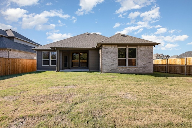 back of house featuring a lawn