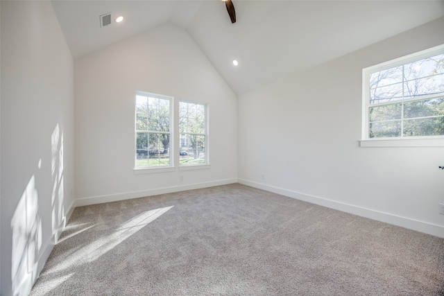 spare room featuring ceiling fan, carpet floors, and vaulted ceiling