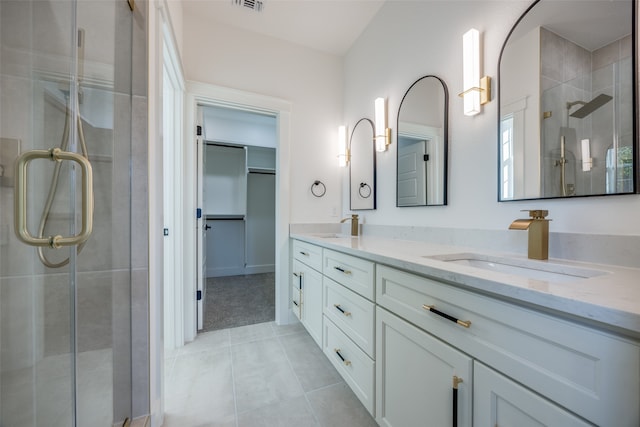 bathroom featuring vanity, tile patterned floors, and a shower with shower door