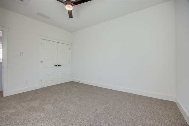 unfurnished bedroom featuring ceiling fan, a closet, and carpet floors