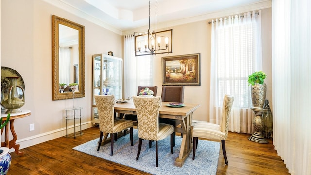 dining room with a healthy amount of sunlight, dark hardwood / wood-style flooring, and a chandelier