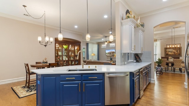 kitchen with decorative light fixtures, light hardwood / wood-style floors, sink, and blue cabinetry