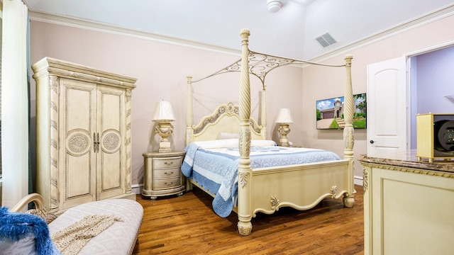 bedroom with wood-type flooring and crown molding