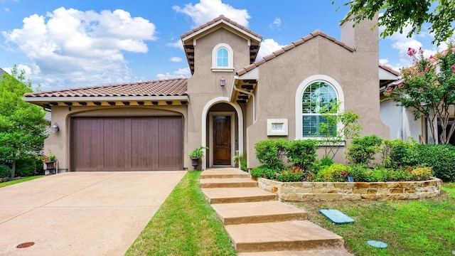 mediterranean / spanish-style house with a garage