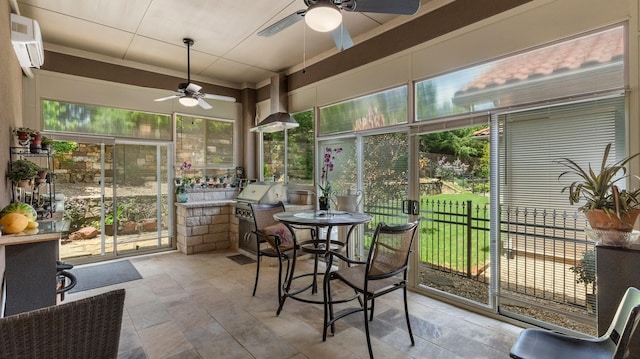 sunroom featuring ceiling fan, a healthy amount of sunlight, and a wall mounted air conditioner