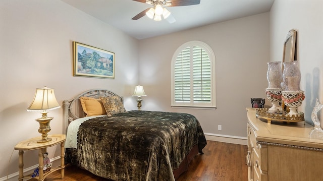 bedroom with ceiling fan and dark hardwood / wood-style floors