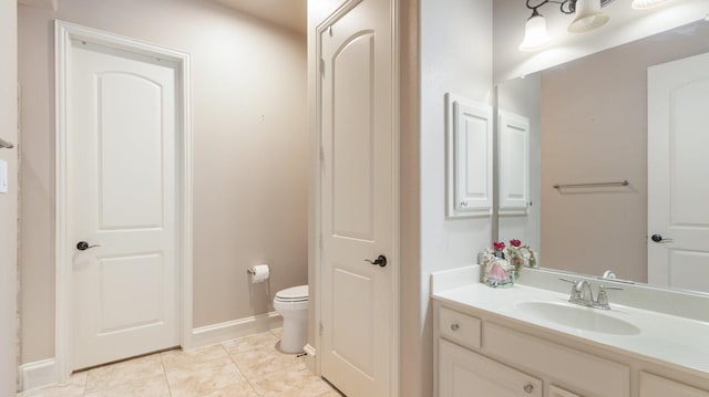 bathroom featuring tile patterned flooring, vanity, and toilet