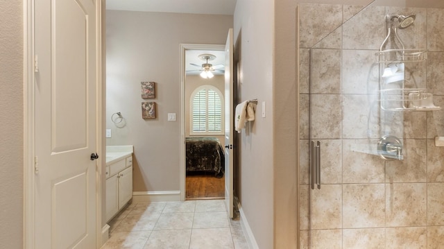 bathroom with tile patterned floors, ceiling fan, vanity, and an enclosed shower