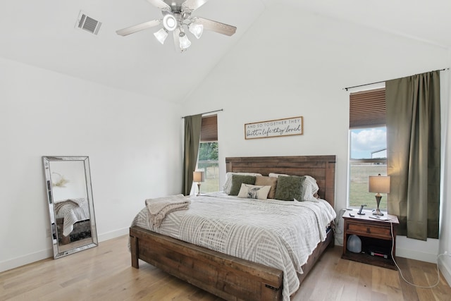 bedroom featuring ceiling fan, high vaulted ceiling, and light wood-type flooring