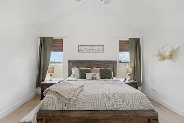 bedroom featuring light wood-type flooring, multiple windows, and ceiling fan