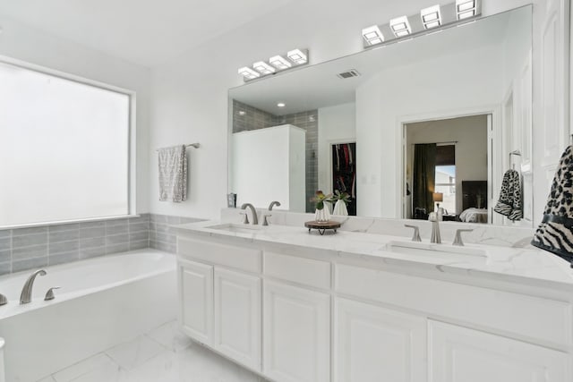 bathroom with vanity and independent shower and bath