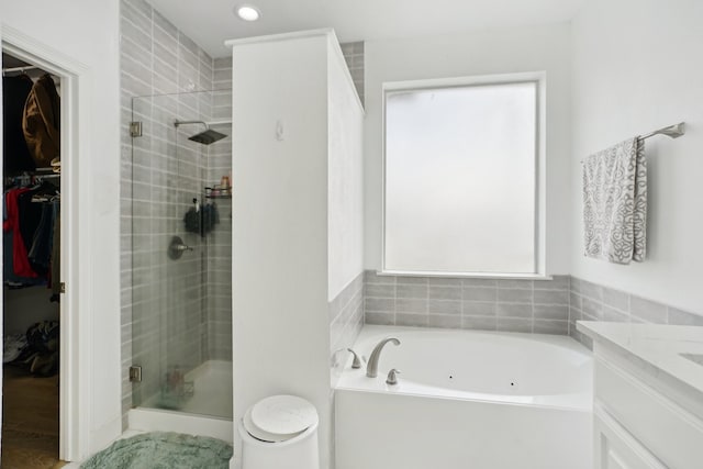 full bathroom featuring toilet, vanity, and shower with separate bathtub