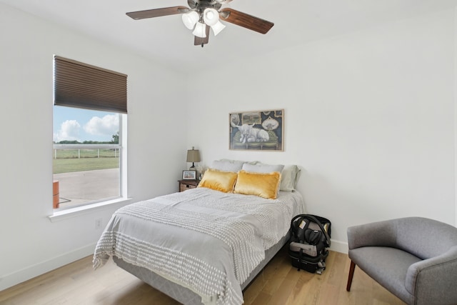 bedroom with ceiling fan and light wood-type flooring