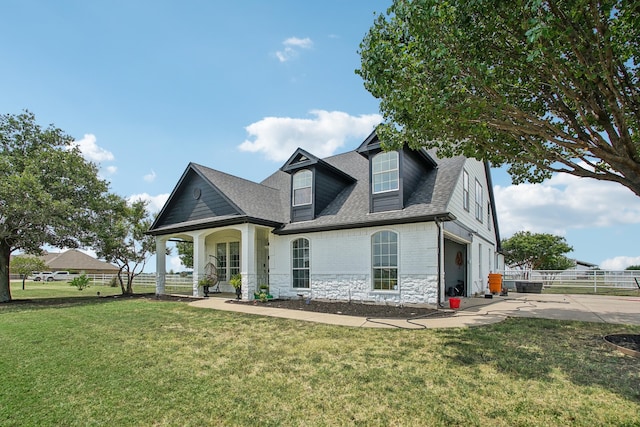 view of front facade with a front yard, a garage, and covered porch