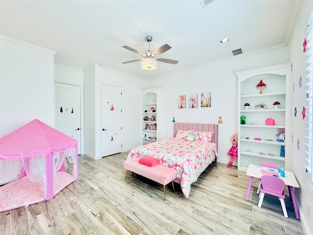 bedroom with light wood-type flooring, ceiling fan, and crown molding