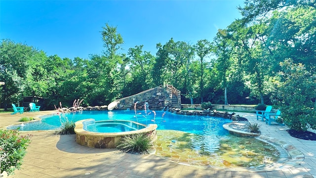 view of swimming pool featuring an in ground hot tub and a patio