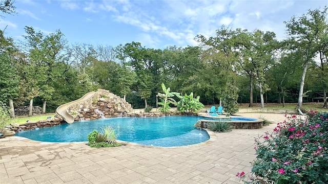 view of pool featuring a patio area and a water slide