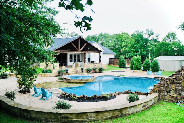 view of pool featuring an in ground hot tub and a patio