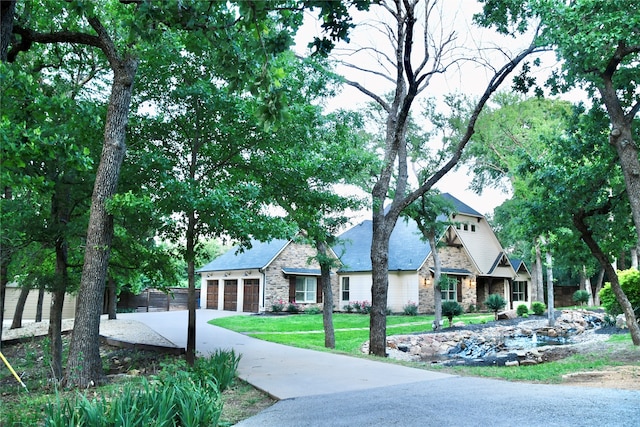 view of front of house with a front yard and a garage