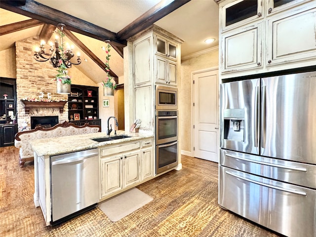 kitchen with lofted ceiling with beams, stainless steel appliances, light stone counters, and sink