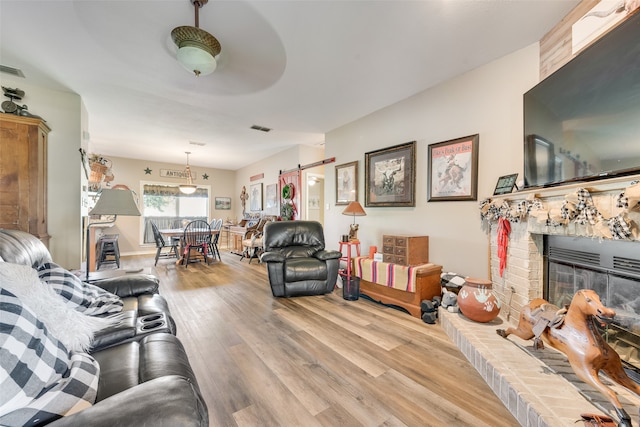 living room featuring a fireplace and light hardwood / wood-style flooring