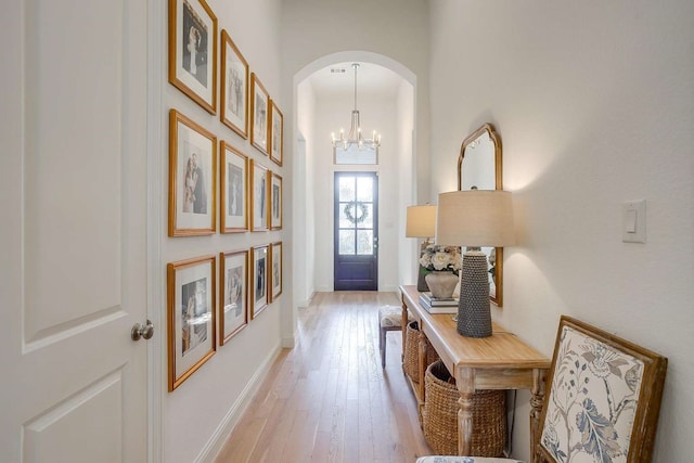 interior space with light hardwood / wood-style floors and a notable chandelier