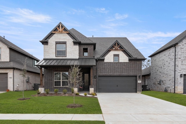 view of front of house with brick siding, a front lawn, central AC, roof with shingles, and a standing seam roof