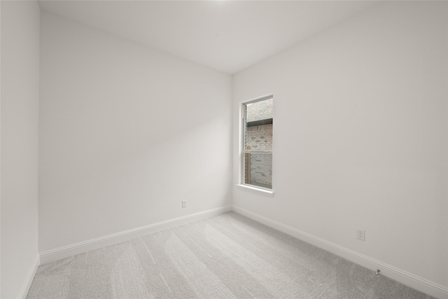 empty room featuring baseboards and carpet floors